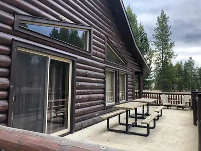 a log cabin with benches on the porch at Mama Bear in Valemount