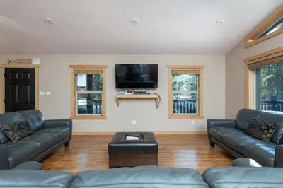 a living room with couches and a flat screen tv at Mama Bear in Valemount
