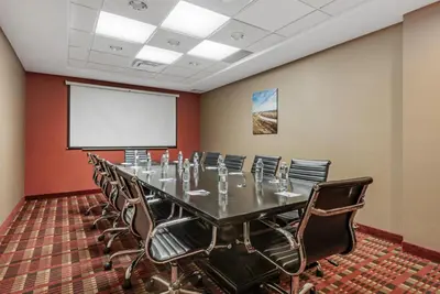 a conference room with a long table and chairs at Best Western Plus Red Deer Inn & Suite in Red Deer