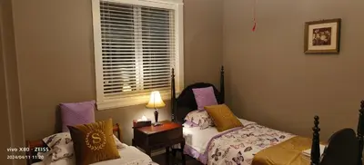 a bedroom with two beds and a window at Sunny Island by White Rock B&B in White Rock