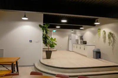 a large empty room with a kitchen and a table at Scott's Inn & Suites in Kamloops