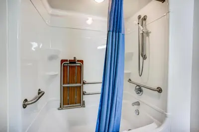 a shower with a blue curtain in a bathroom at Motel 6-Red Deer, AB in Red Deer