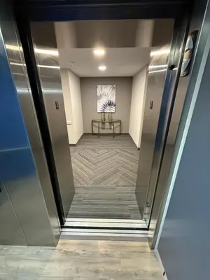 an elevator lobby with a table and a painting on the wall at Days Inn by Wyndham Stony Plain in Stony Plain