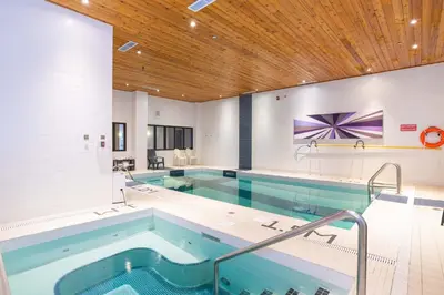 a large swimming pool with a large tub at Sandman Signature Edmonton South Hotel in Edmonton