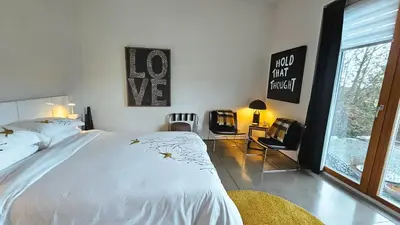 a bedroom with a large white bed and a window at The Cube Cow Bay Suite in Cowichan Bay