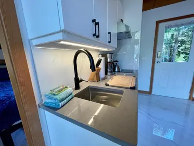 a kitchen with a sink and aaucet at Private Oceanfront Cabin And Hot Tub! - Gww in Ucluelet