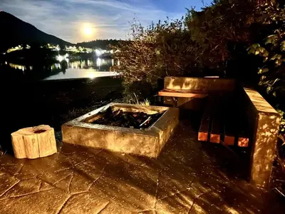 a bench and a fire pit next to a table at Private Oceanfront Cabin And Hot Tub! - Gww in Ucluelet