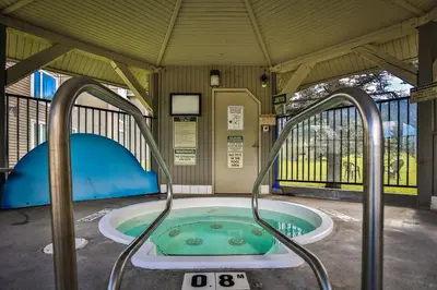 a jacuzzi tub in a pavilion with a gate at Timberline Lodge by StayIn in Fernie