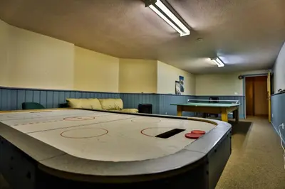 a large ping pong table in a room at Timberline Lodge by StayIn in Fernie