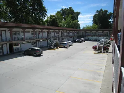 a parking lot with cars parked in front of a building at Spanish Villa Resort in Penticton