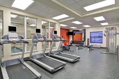 a gym with treadmills and elliptical machines at Hampton Inn & Suites Red Deer in Red Deer