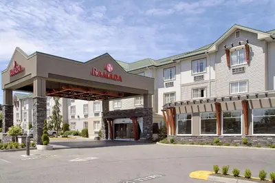a hotel with a sign on the front of it at Ramada by Wyndham Surrey/Langley in Surrey