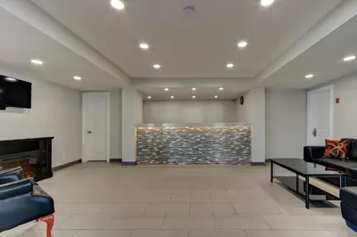 a lobby with couches and a stone wall at Knights Inn Kamloops in Kamloops