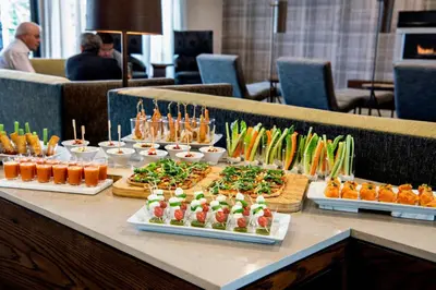 a buffet line of food on a table at Courtyard by Marriott Edmonton West in Edmonton