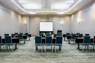 a conference room with tables and chairs and a whiteboard at Courtyard by Marriott Edmonton West in Edmonton