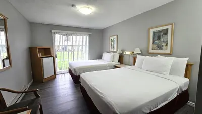a hotel room with two beds and a window at Okanagan Seasons Resort in Kelowna
