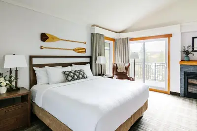 a bedroom with a large bed and a fireplace at Pyramid Lake Lodge in Jasper