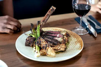 a plate of food on a table with a glass of wine at The Crimson Jasper in Jasper