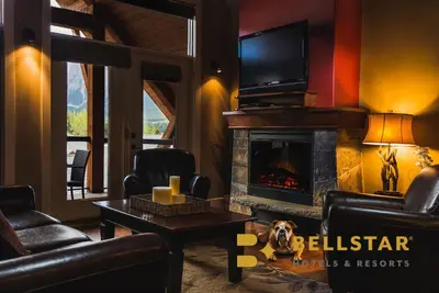 a living room with a fireplace and a tv at Bellstar Suites at Solara Resort in Canmore