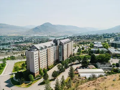 an aerial view of a city with mountains at Residence & Conference Centre - Kamloops in Kamloops
