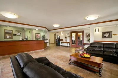 a living room with a couch and a table at Super 8 by Wyndham Slave Lake AB in Slave Lake