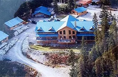 an aerial view of a house with a blue roof at Glenogle Mountain Lodge and Spa in Golden