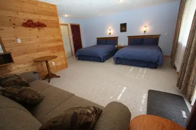 a living room with two beds and a couch at Glenogle Mountain Lodge and Spa in Golden