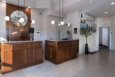 a lobby with a reception desk and a mirror at Prestige Beach House, WorldHotels Crafted in Kelowna