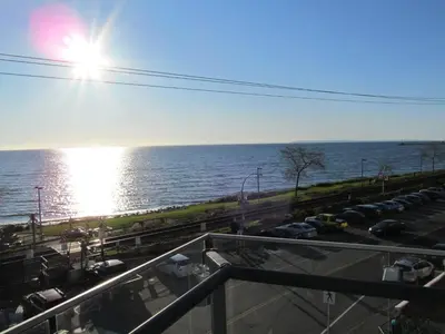 a view of a parking lot next to the water at Ocean Promenade Hotel in White Rock
