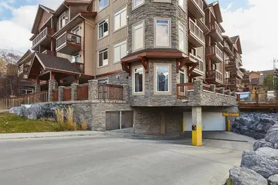 a large apartment building with a street in front of it at Mountain View Escape with open hot tub, Views!! in Canmore