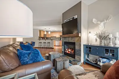 a living room with a couch and a fireplace at RidgeView Loft - Top Floor 2 Bed 2 Bath, Amazing Views in Canmore
