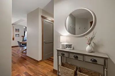 a mirror on a wall above a dresser in a hallway at RidgeView Loft - Top Floor 2 Bed 2 Bath, Amazing Views in Canmore