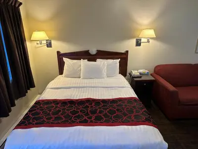 a hotel room with a bed and a couch at Kings Motor Inn in Kamloops