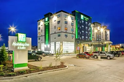 a large building with cars parked in a parking lot at Holiday Inn Hotel & Suites - Calgary Airport North by IHG in Calgary