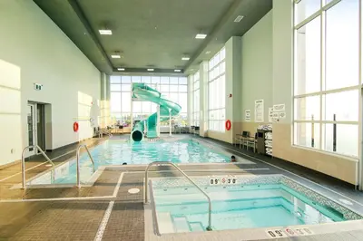 a swimming pool with a slide in a building at Holiday Inn Hotel & Suites - Calgary Airport North by IHG in Calgary