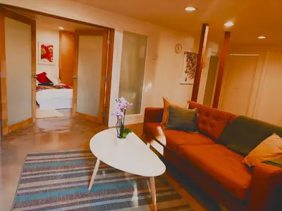 a living room with a couch and a table at U of A Homestay, Trails & Whyte Ave in Edmonton