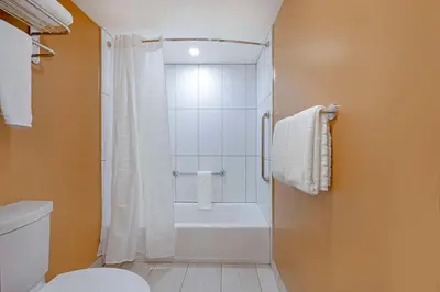 a bathroom with a shower and a toilet at Best Western Plus Emerald Isle Hotel in Sidney