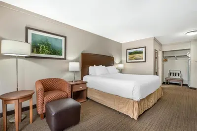 a hotel room with a bed and a chair at Best Western The Westerly Hotel in Courtenay