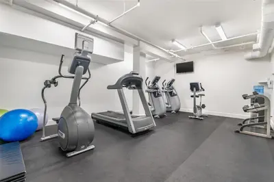 a gym with several treadmills and exercise bikes at Best Western The Westerly Hotel in Courtenay