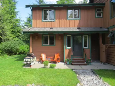 a house with orange chairs and a patio at Summerhill Guest House in Tofino