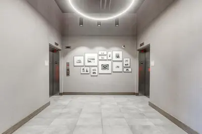 a hallway with pictures on a wall in a museum at Marquee on 16th in Calgary
