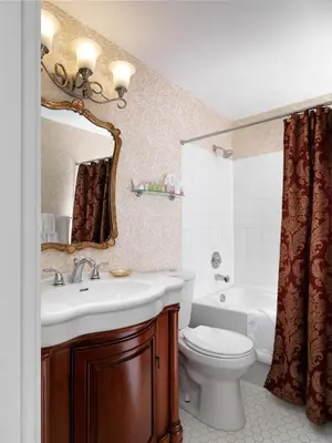 a bathroom with a sink and a toilet and a mirror at Pendray Inn and Tea House in Victoria