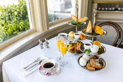 a table with a tray of breakfast foods and coffee at Pendray Inn and Tea House in Victoria