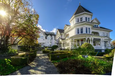 a large white house with a pathway in front of it at Pendray Inn and Tea House in Victoria