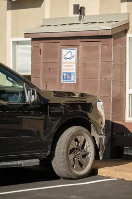a black truck parked in front of a building at Fernie Fox Hotel in Fernie