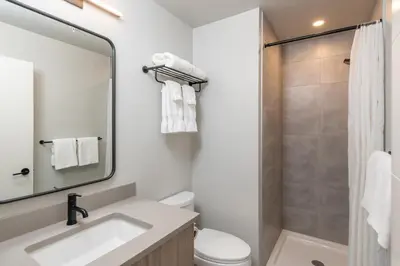 a bathroom with a sink and a toilet and a shower at Harrison Beach Hotel in Harrison Hot Springs
