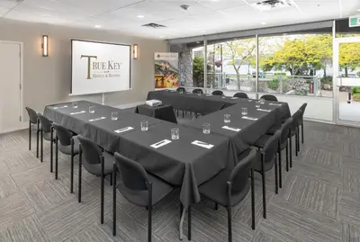 a conference room with a large table and chairs at Harrison Beach Hotel in Harrison Hot Springs