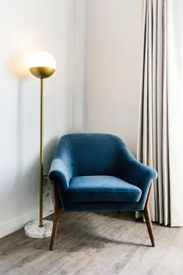 a blue chair in a room with a lamp at Glacier View Lodge in Sunwapta