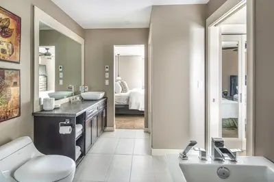 a bathroom with a sink and a toilet and a mirror at Bighorn Meadows Resort in Radium Hot Springs