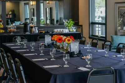 a table with a blue table cloth and flowers on it at Bighorn Meadows Resort in Radium Hot Springs